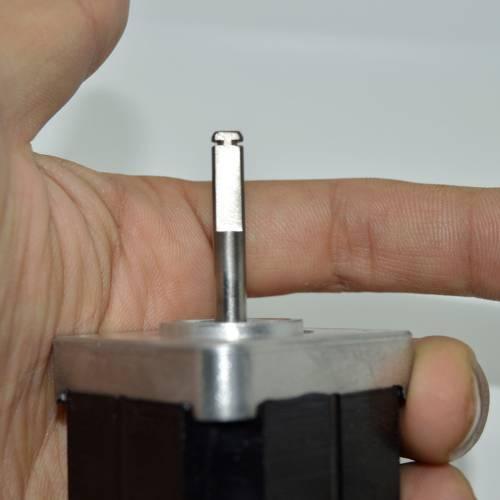 Minebea Japan d Cut Shaft NEMA 17 Stepper Motor For 3d Printer CNC - close-up view of the silver metal D-cut shaft held by a hand.