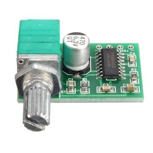 Mini 2 Channel Digital USB Audio Amplifier Board Module PAM8403 With Volume Control Potentionmeter - green circuit board, a silver volume control knob, and a cylindrical capacitor.