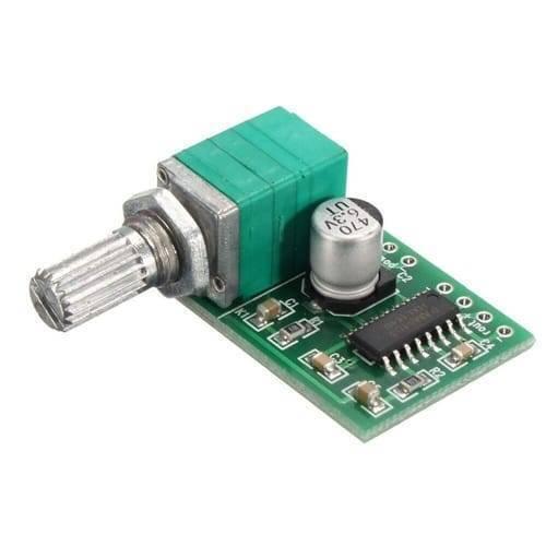 Mini 2 Channel Digital USB Audio Amplifier Board Module PAM8403 With Volume Control Potentionmeter - green potentiometer knob, a silver capacitor, and a small black integrated circuit.