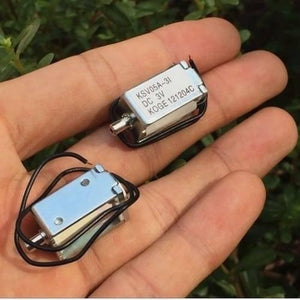 Mini 3V DC Solenoid Valve KSV05A Normally Open For Gas Air Valve - two silver rectangular metal valves with black wires held in a hand, showing the KSV05A-3I DC 3V KOGE label.