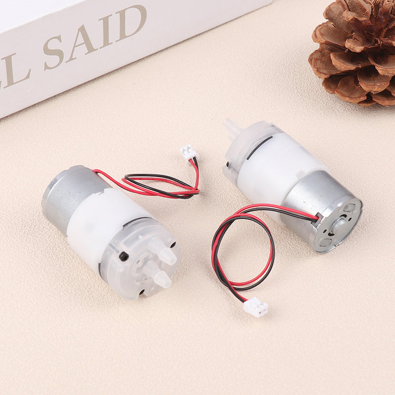 Mini 5V Water Pump Diaphragm Pump Micro Self Priming Suction Drinking Fountain Water Pump Water Dispenser Pump - two silver and white micro pumps with attached red and black wires featuring white connectors on a beige surface.