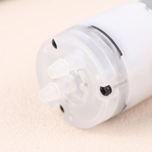 Mini 5V Water Pump Diaphragm Pump Micro Self Priming Suction Drinking Fountain Water Pump Water Dispenser Pump - close-up view of the translucent white plastic pump head featuring two protruding hose connectors and a visible black mounting screw.