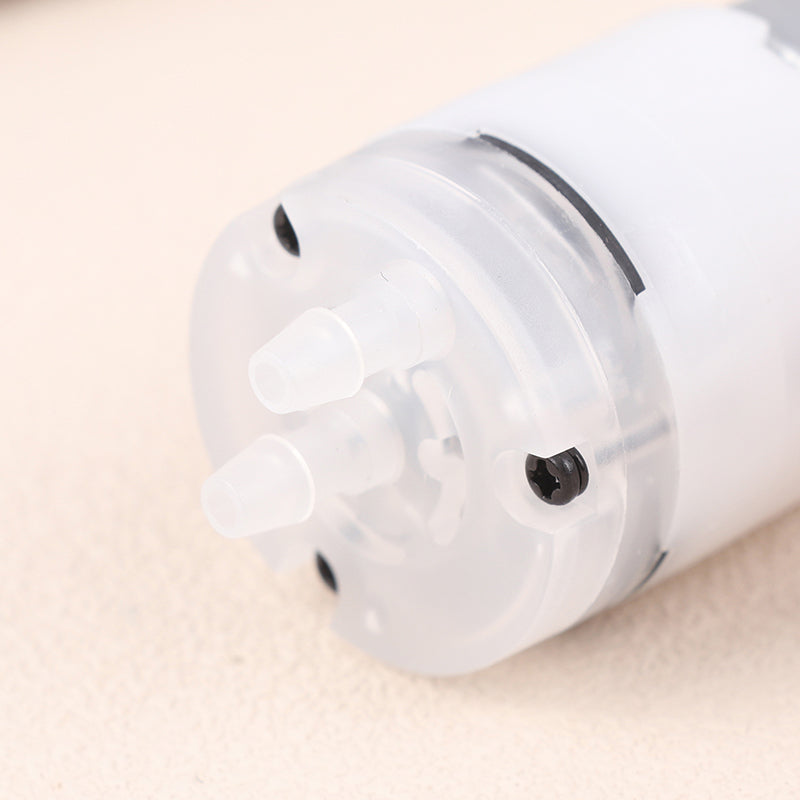 Mini 5V Water Pump Diaphragm Pump Micro Self Priming Suction Drinking Fountain Water Pump Water Dispenser Pump - close-up view of the translucent white plastic pump head featuring two protruding hose connectors and a visible black mounting screw.