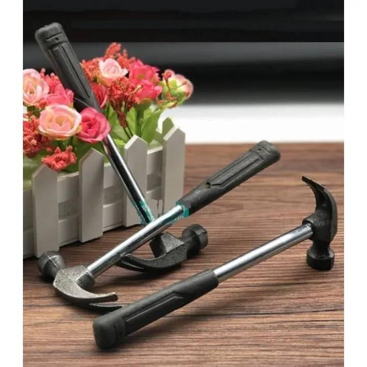 Mini Craft DIY Claw Hammer Ckl-010 For Students - two small hammers with black rubber handles and metal heads resting on a wooden surface near a flower pot.