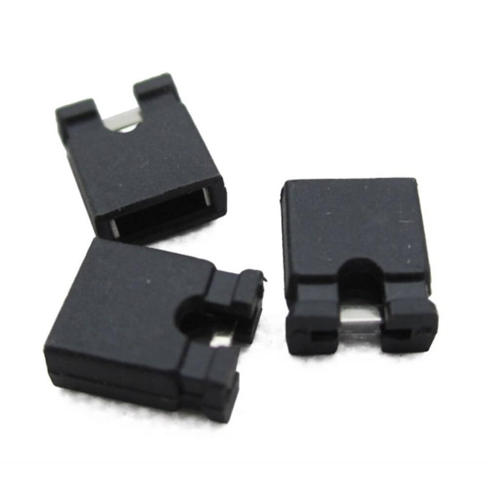 Mini Jumpers Hard Drive Jumper - three small black plastic connector caps with exposed metal contacts arranged on a white background.