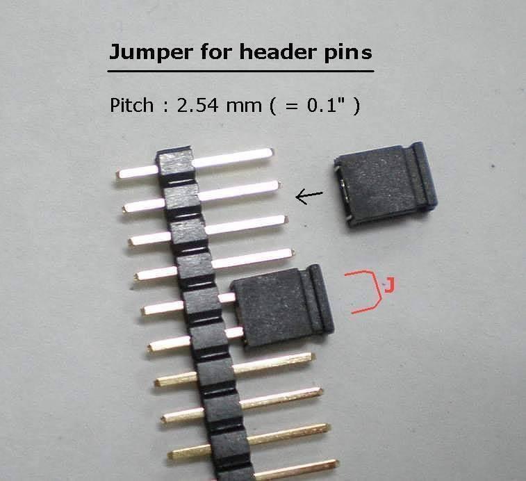 Mini Jumpers Hard Drive Jumper - shown as a close-up of two black plastic jumpers positioned on a strip of metal header pins with a 2.54 mm pitch.