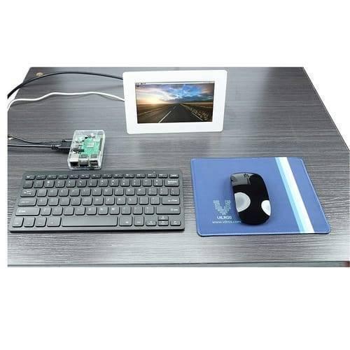 Mini Wireless Keyboard And Mouse For Raspberry Pi - shown with a black keyboard, black mouse on a blue mousepad, and a small screen displaying a landscape.