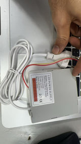 Mirror LED power supply - a white rectangular unit with a connected power cord and plug, showing a label with technical specifications.