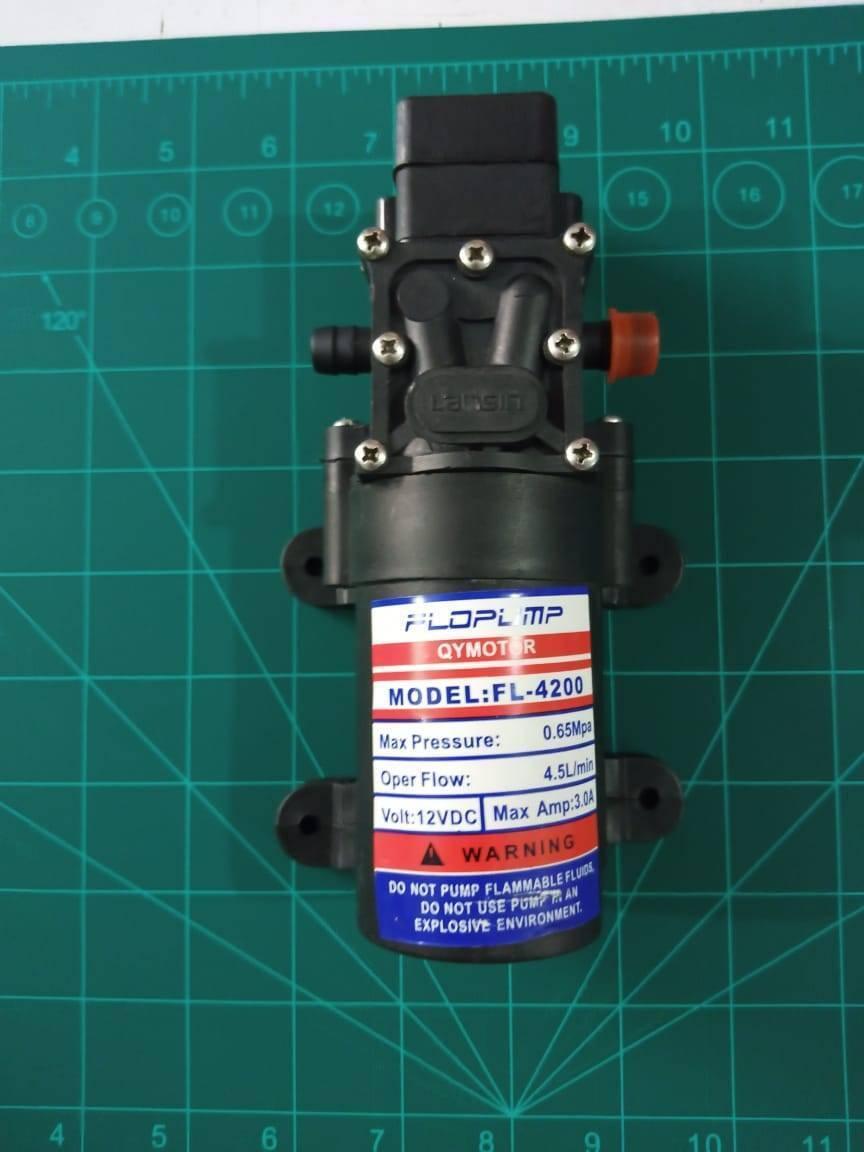Mist Pump High Pressure Low Noise 12V 70W 4.5l/min Fog Maker Pump - a black 12V DC motor pump with two ports, shown against a green cutting mat.