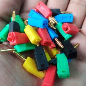 Mix Color 2mm Banana Plug For Electrical And Electronics Lab Trainers - shown as a handful of assorted red, yellow, blue, green, and black connectors.