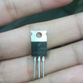 MJ13009 Transistor High Performance NPN Transistor for Electronics Projects - a black three-pin NPN transistor held between fingers, showing the J13009-2 and B44HH markings on its front surface.