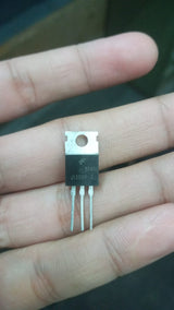 MJ13009 Transistor High Performance NPN Transistor for Electronics Projects - a black three-pin NPN transistor held between fingers, showing the J13009-2 and B44HH markings on its front surface.