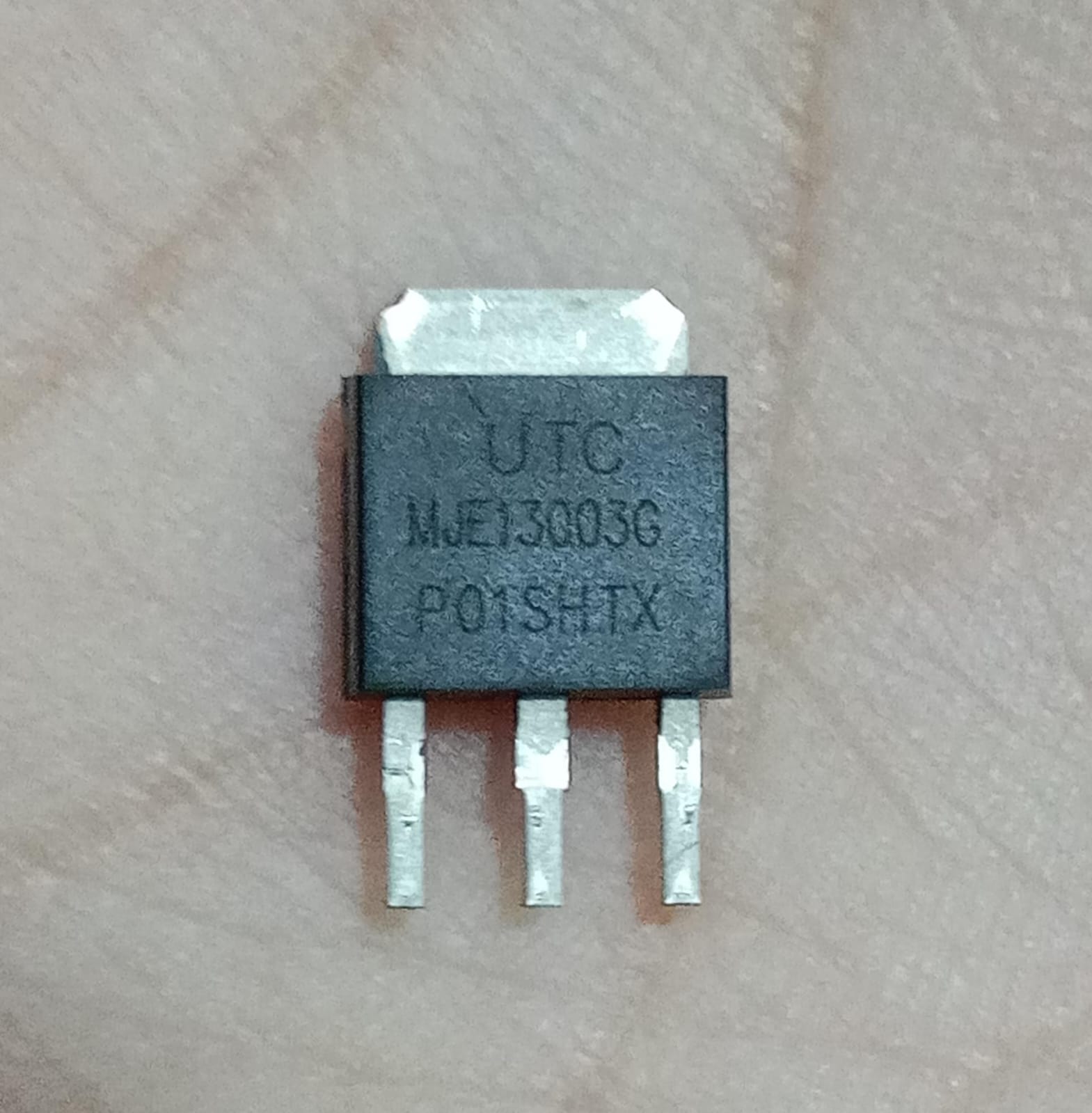 MJE13003G 700V 1.5A NPN Power Transistor - a black, three-pin electronic component with a silver metal heat sink tab, showing the text UTC MJE13003G P01SHTX.