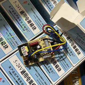 MK4T 5-24 Universal Adjustable Power Module - shown as a circuit board with attached coloured wires, resting on top of multiple branded product boxes.