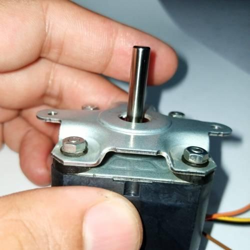 ML17A3 Bipolar NEMA17 Stepper Motor With Shock Absorber - a close-up view showing the metallic shaft and the attached shock absorber held by a hand.