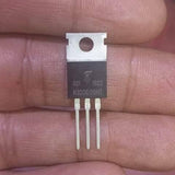 MOSFET transistor K100E08N1 - a black three-pin electronic component with a metal heat sink tab, held between fingers.