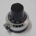 Multi-turn potentiometer knob with dial knob 3590S potentiometer knob with switch lock switch - black and silver circular dial with a locking switch and numbered markings from 0 to 9.