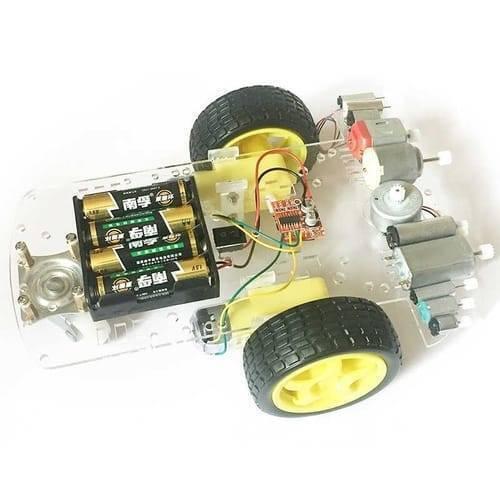 MX1508 Mini Dual Channel 1.5A DC Motor Driver Module Mini L298N Replacement - mounted on a clear acrylic robot chassis with two yellow wheels, a battery holder, and motors.