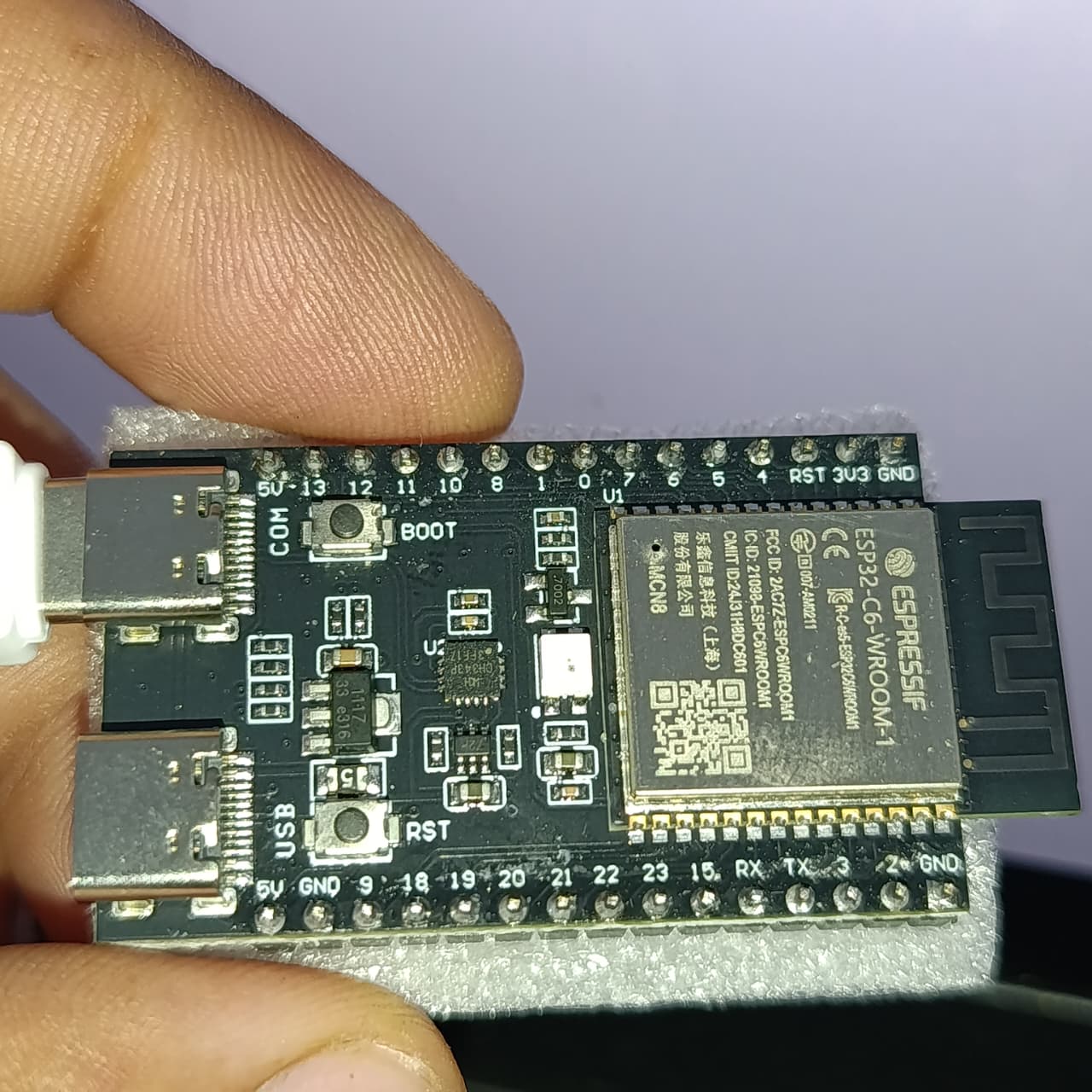 NANOESP32-C6 Development Board | ESP32-C6-WROOM-1-N4 | WiFi 6 + Zigbee + Thread | RISC-V 160MHz | 4MB Flash | Dual USB-C | RGB LED - held in hand, showing a black PCB with two USB-C ports, BOOT and RST buttons, and an ESP32-C6-WROOM-1 module.