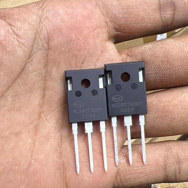 NCE 80TD65 IGBT MOSFET Power Semiconductor - two black three-pin power semiconductor components held in a hand, showing the printed model number and markings.