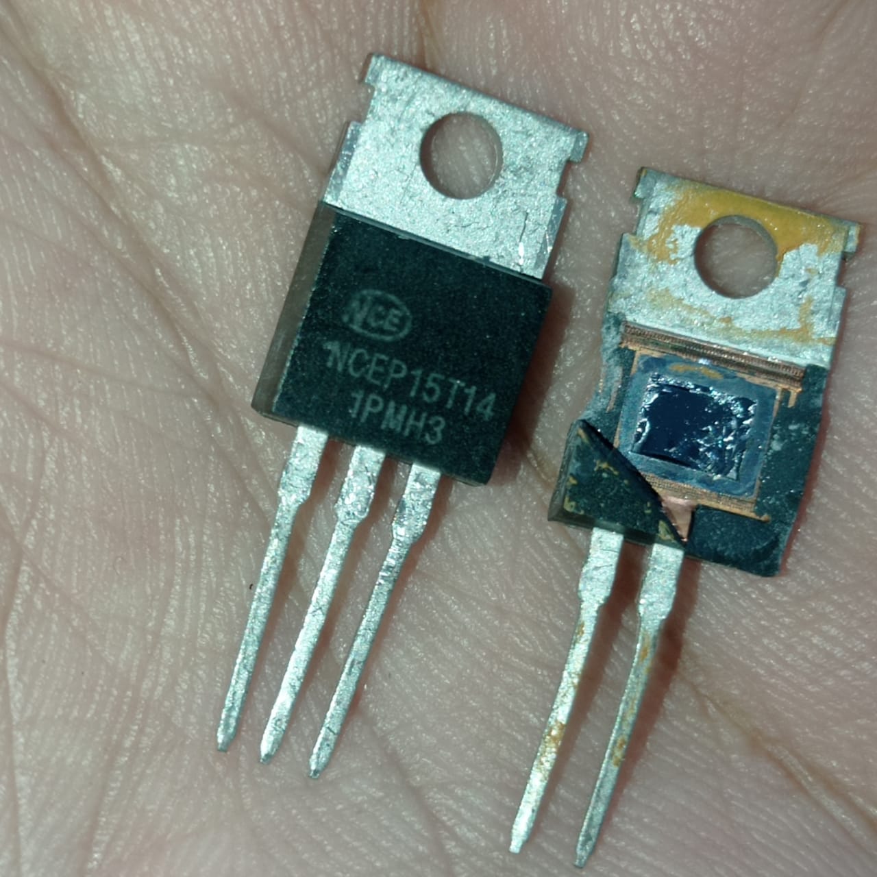 NCEP15T14 MOSFET – 150V, High-Efficiency Power Transistor for DC-DC Converters, Motor Drivers, Arduino Projects - two black TO-220 power transistors held in a hand, one intact with visible text and one with the casing partially broken.