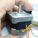 NEMA 17 Single Shaft 1.8 Degree Compact Powerful Stepper Motor - the silver metal body, rotating shaft, and multi-coloured wires.