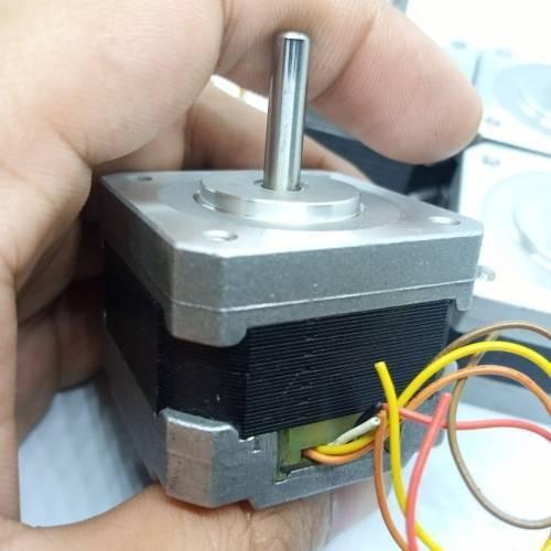 NEMA 17 Single Shaft 1.8 Degree Compact Powerful Stepper Motor - the silver metal body, rotating shaft, and multi-coloured wires.