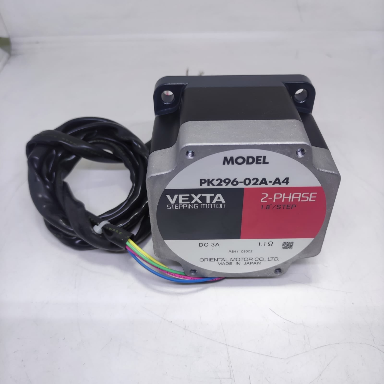 NEMA 34 Stepper Motor PK296-02A-A4 | Made In Japan | Digilog.pk - a black and silver motor with a label listing specifications and a coiled black cable with four coloured wires.