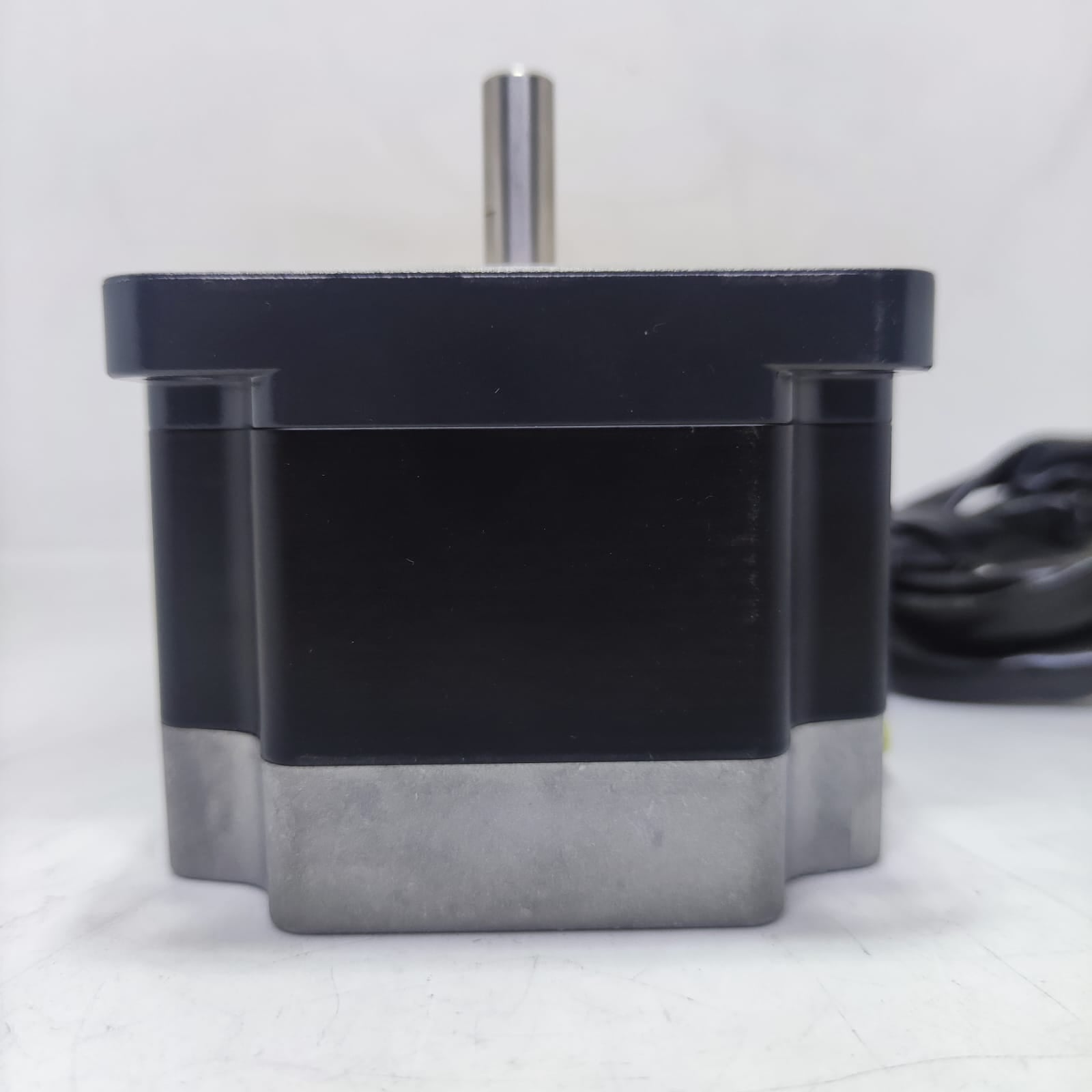 NEMA 34 Stepper Motor PK296-02A-A4 | Made In Japan | Digilog.pk - a black and silver cylindrical motor with a top-facing metal shaft and a black cable coiled in the background.