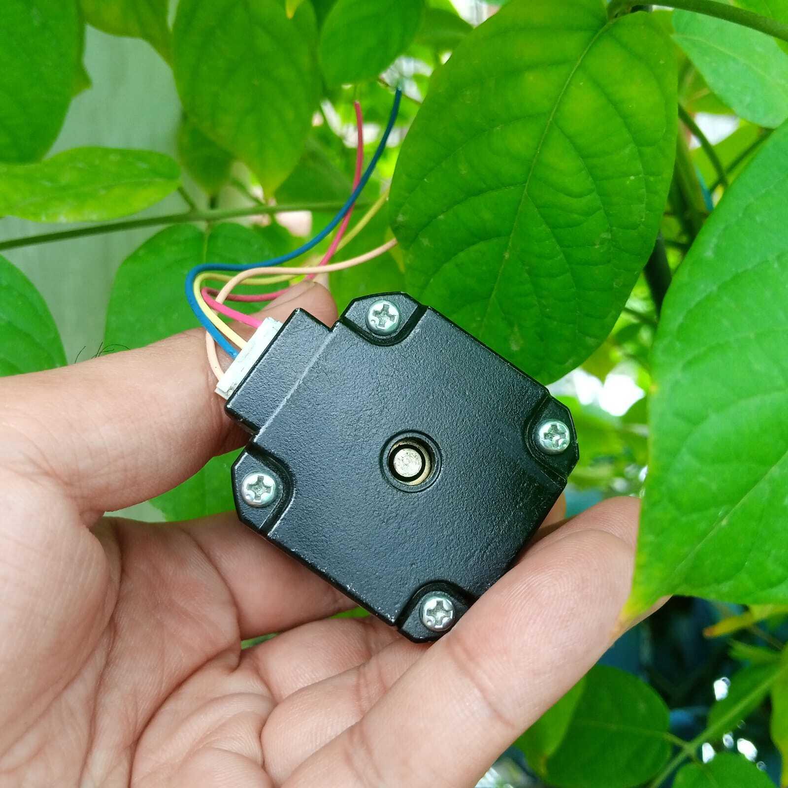 NEMA17 Stepper Motor 1.5A Maximum 48mm Height A4988 DRV8825 Compatible Bipolar Stepper Motor - black square motor held in a hand with a white multi-pin connector and four colored wires extending from the side.