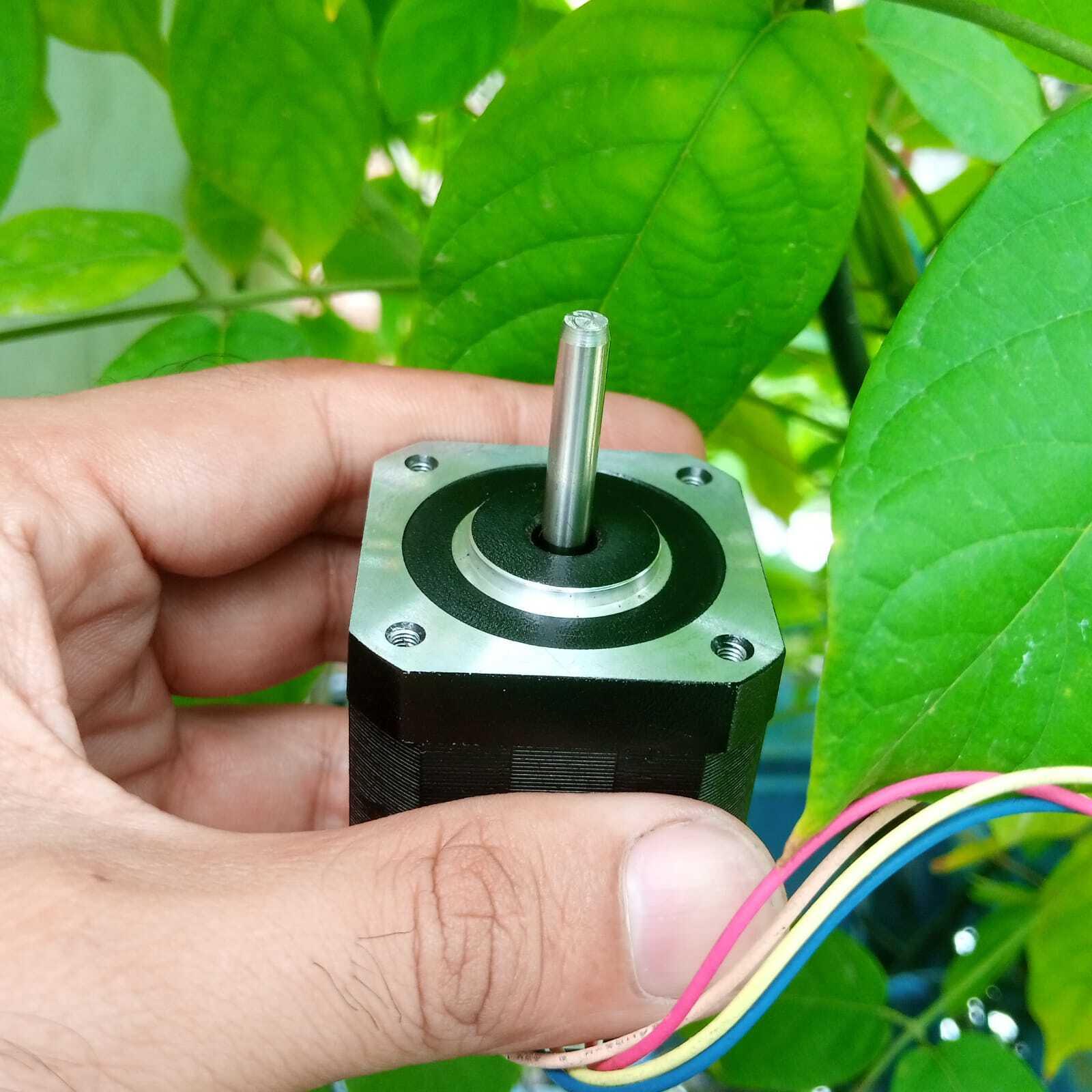 NEMA17 Stepper Motor 1.5A Maximum 48mm Height A4988 DRV8825 Compatible Bipolar Stepper Motor - with a silver shaft and four colored wires against green leaves.