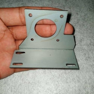 NEMA17 Stepper Motor Mounting Bracket NEMA17 Fitting - a grey L-shaped metal plate with a central circular cutout and four mounting holes, held in a hand.