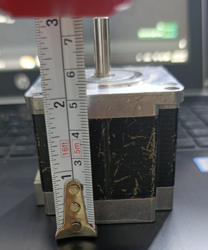 NEMA23 Bipolar 1.8 Degree 2.1A 54mm Stepper Motor 6.35mm Shaft Torque 15kg/cm Refurnished - shown in a side-view close-up with a measuring tape placed against its body to indicate its height.