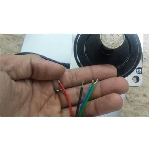 NEMA34 NEMA 34 6nm Torque 75mm Stepper Motor For 3d Printer & CNC - a close-up of the motor body with a coin on top and four exposed wire leads held in a hand.