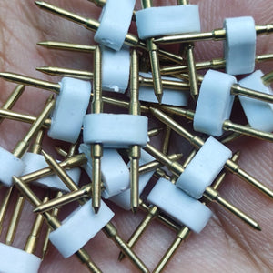 Neon Light Connector Pin - a close-up shot showing a pile of small white plastic connectors with two gold-colored metal pins each.