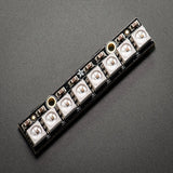 NeoPixel Stick 8x5050 RGB LED with WS2812 Driver - 8-Bit LED Strip Module - a black rectangular circuit board featuring eight square RGB LEDs arranged in a single straight row.