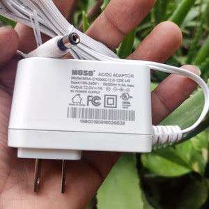 New High Quality 220V To 12V 1A AC DC Adapter - a white wall-plug power supply with a barrel connector and printed technical specifications on its body.