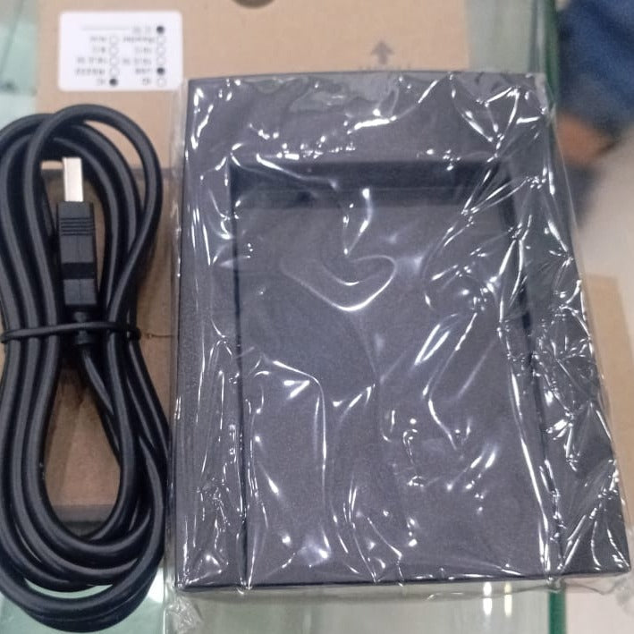 NFC Reader - shown in its black box packaging with a protective plastic film, accompanied by a black USB cable.