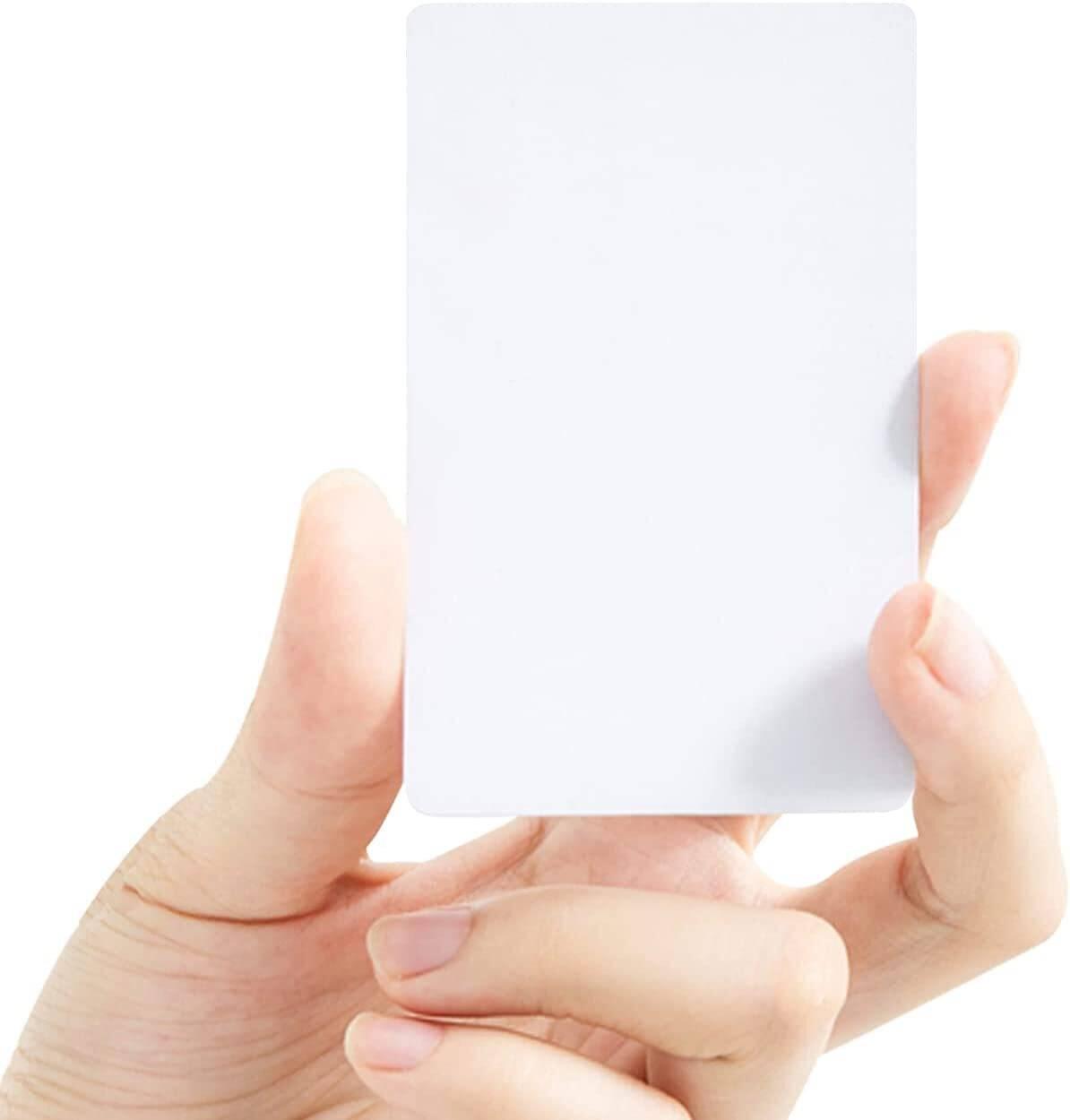 NFC Tag 13.56MHz RFID Card RFID Tag 1k Memory - Blank white NFC card held between finger and thumb, shown plain with no printing on its face.