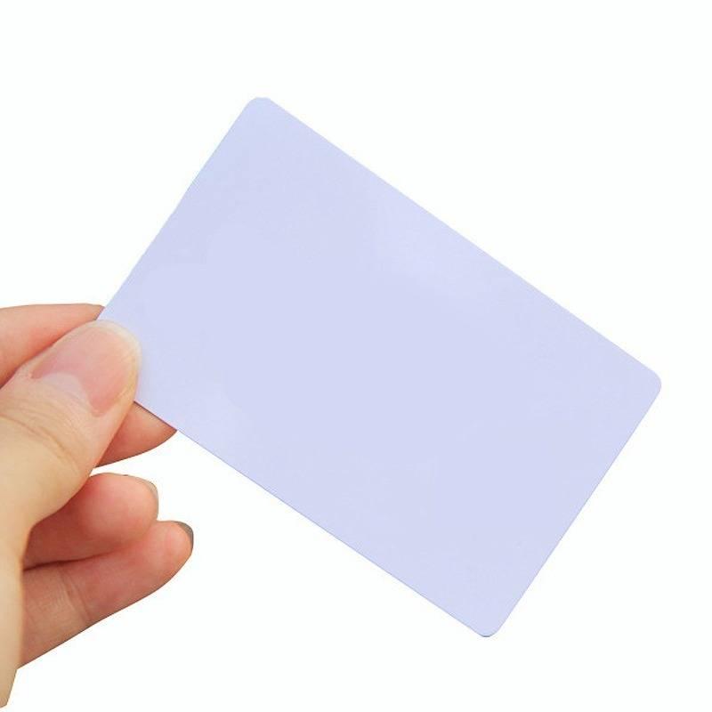 NFC Tag 13.56MHz RFID Card RFID Tag 1k Memory - shown as a plain, rectangular white plastic card held between a person's thumb and fingers.