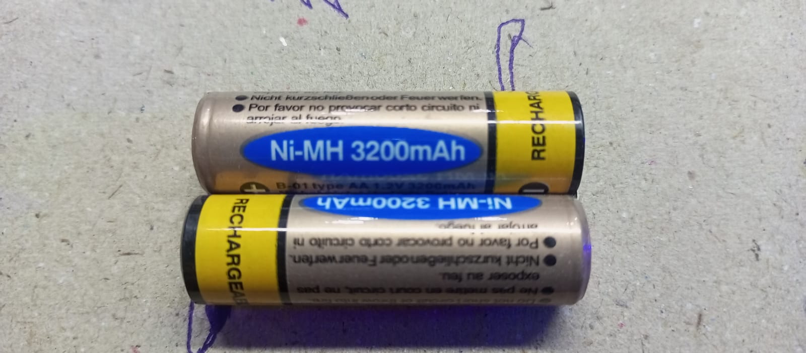 Ni Mh 1000mAh Battery - shown as two cylindrical AA rechargeable batteries with gold and blue labels marked with 3200mAh capacity.