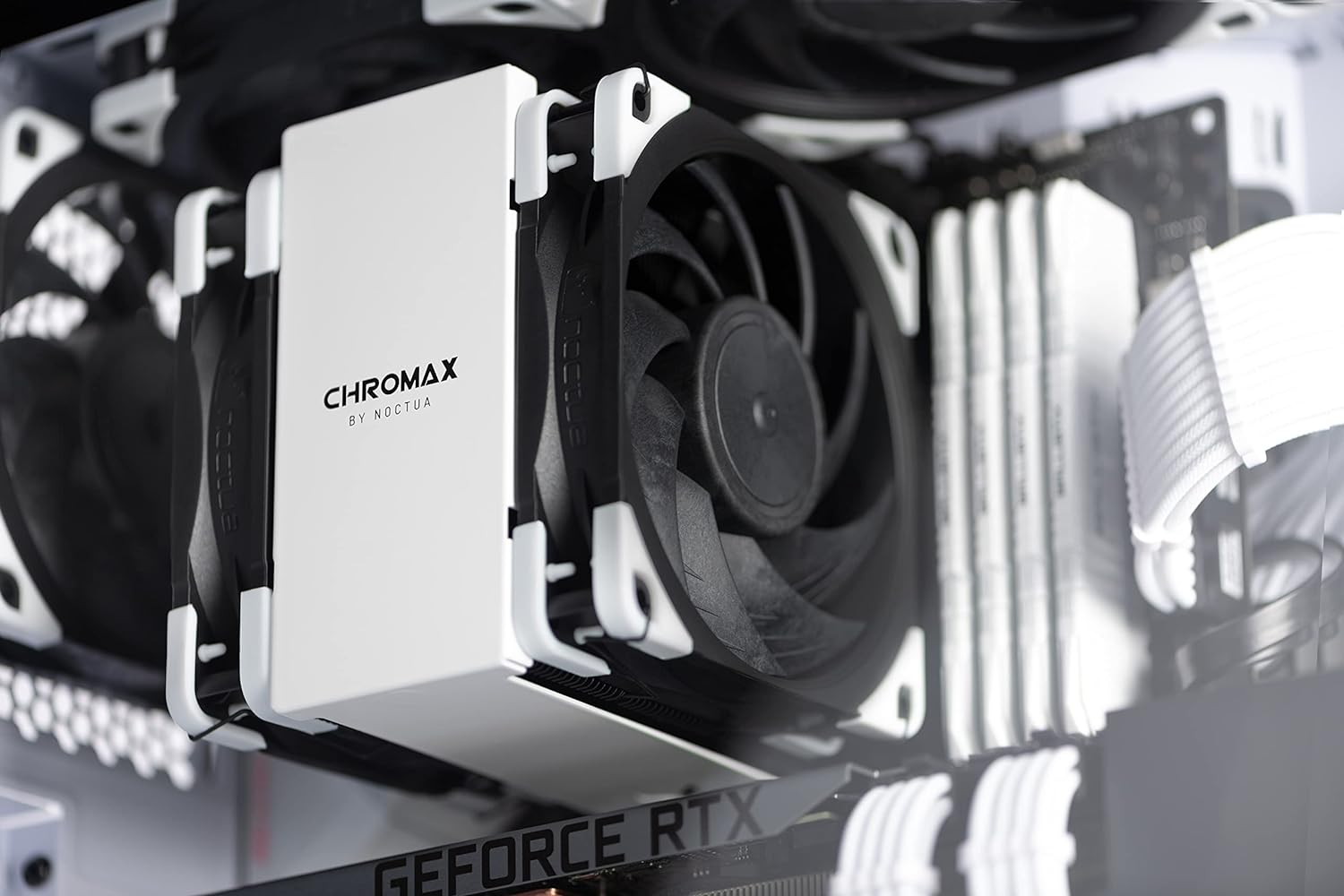 Noctua NA-SAVP1 chromax.White, Anti-Vibration Pads - installed on the corners of a black Noctua CPU cooling fan mounted on a white heatsink inside a PC case.
