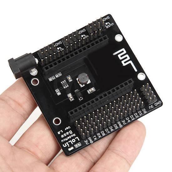 NodeMcu Sensor Shield GPIO Board - a black expansion board held in a hand, featuring a DC power jack, pin headers, and labeled GPIO ports.