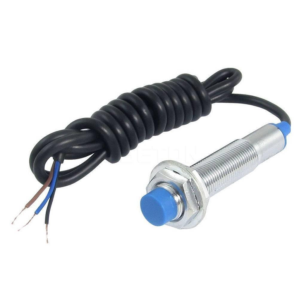 NPN Inductive Proximity Sensor - a cylindrical metal sensor with a blue tip and a coiled black cable with three exposed wire leads.
