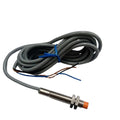 NPN Proximity Sensor - shown as a cylindrical metal threaded sensor with an orange tip, connected to a long grey cable with three exposed wire ends.