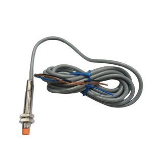 NPN Proximity Sensor - a threaded metal cylindrical body with an orange tip and an attached gray cable with exposed brown, blue, and black wires.