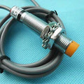Omron Inductive Proximity Sensor Switch E2e-X2E1 - a cylindrical metal sensor with an orange tip, two mounting nuts, and an attached grey cable.