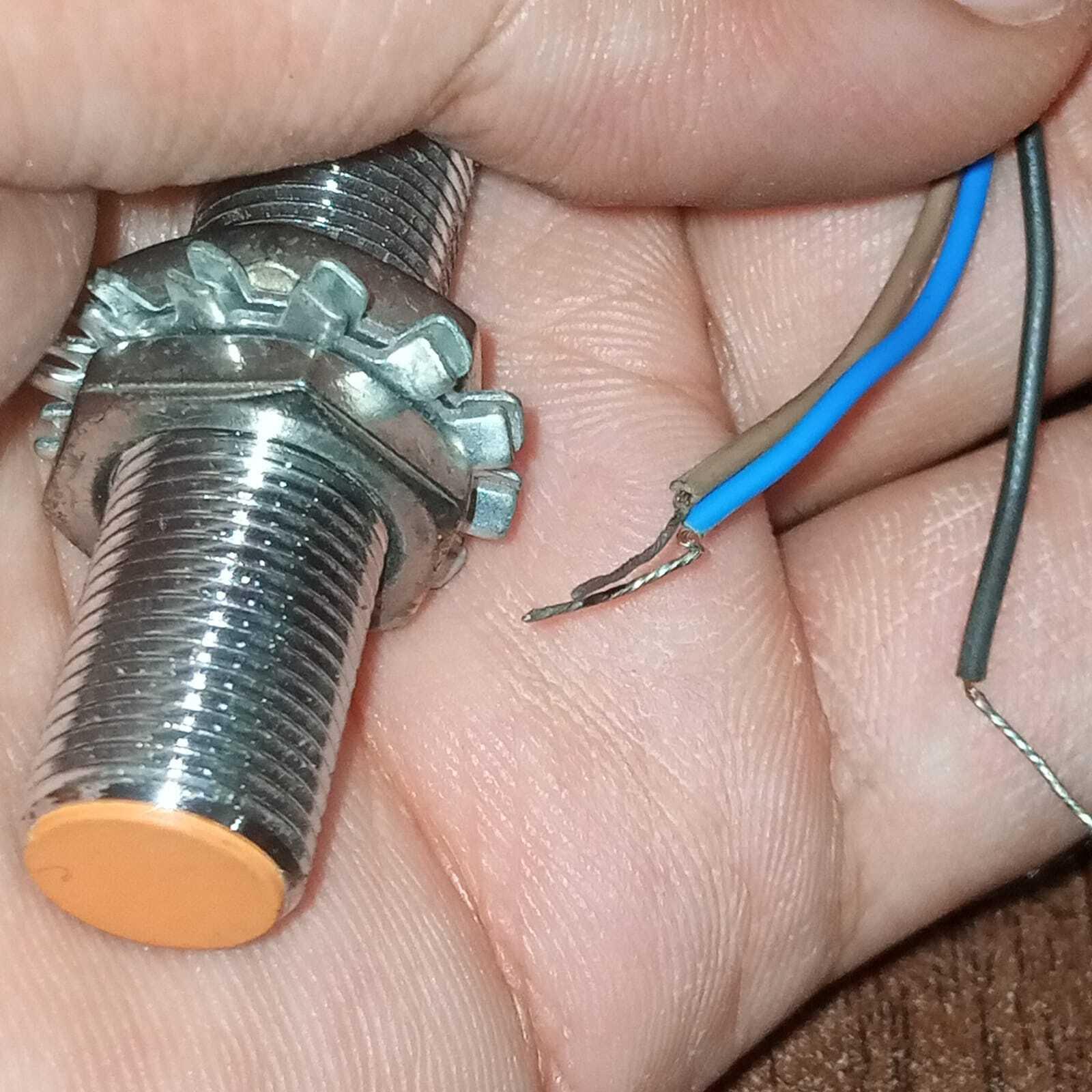 Omron Inductive Proximity Sensor Switch E2e-X2E1 - shown as a close-up of the threaded metal cylinder with an orange tip and three exposed wire leads.