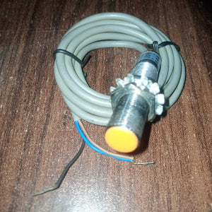Omron Inductive Proximity Sensor Switch E2e-X2E1 - a cylindrical metal sensor with an orange tip, mounting nuts, and a coiled grey three-wire cable.