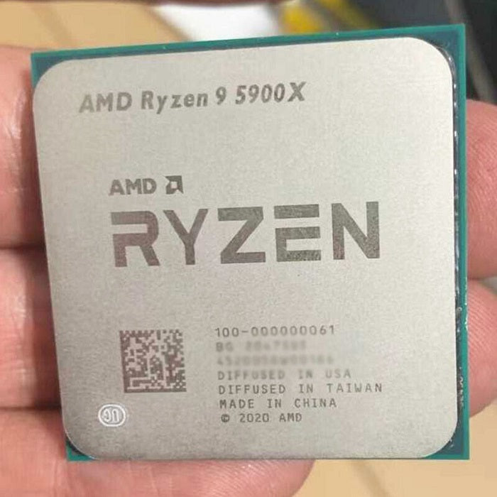 On Demand AMD Ryzen 9 R9 5900X Processor 12 cores and 24 threads CPU for Gaming & Multitasking - a close-up shot of the square silver metal heat spreader held in a hand, showing etched text and a QR code.